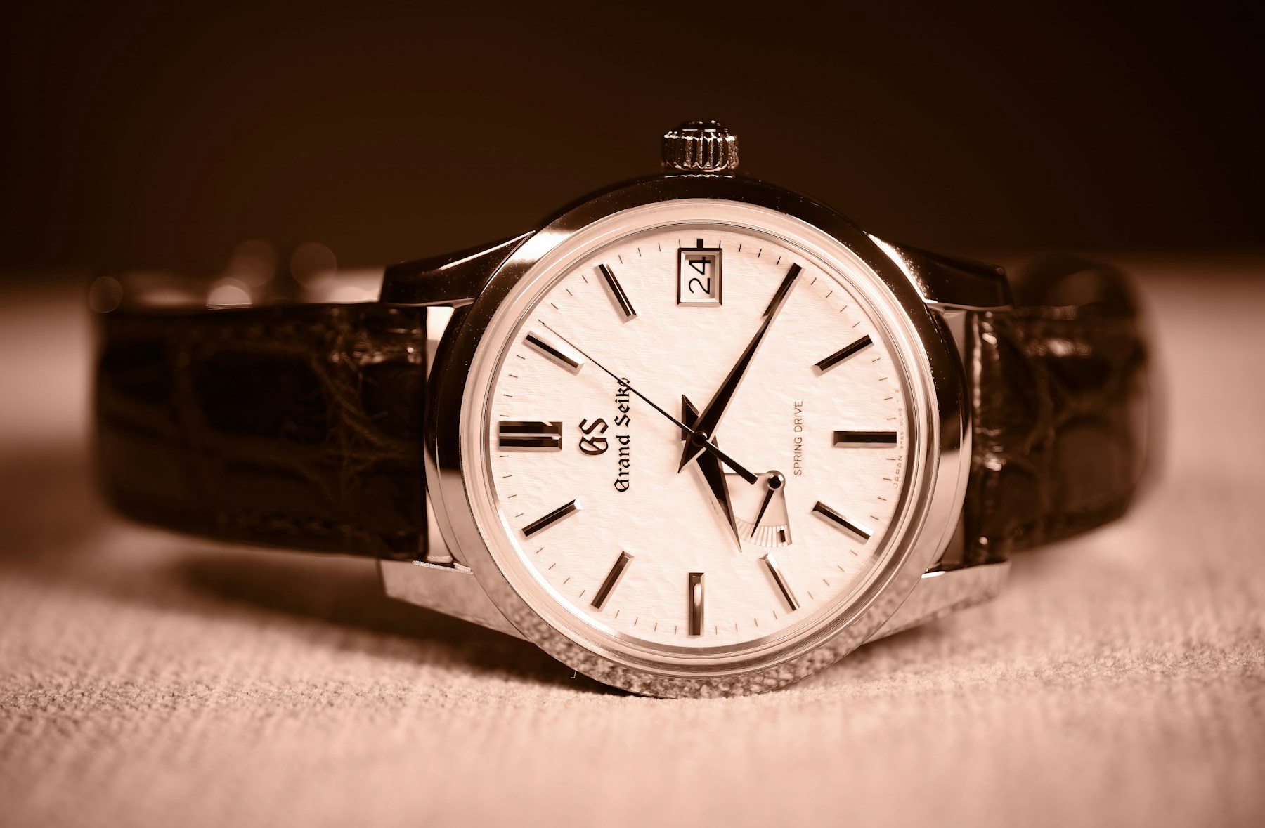 Grand Seiko Spring Drive watch with a light textured dial and black leather strap