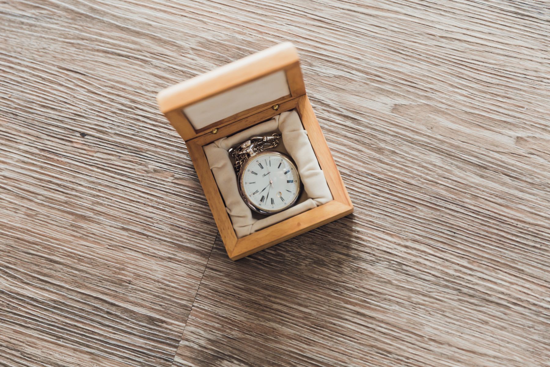 Vintage wristwatch presented inside a wooden watch box